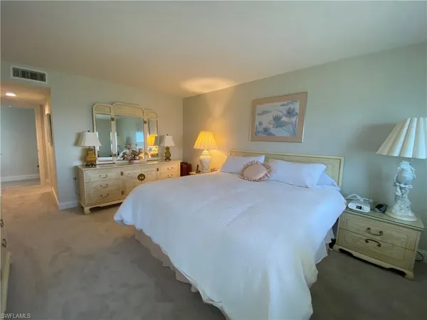 a bedroom with bed and window