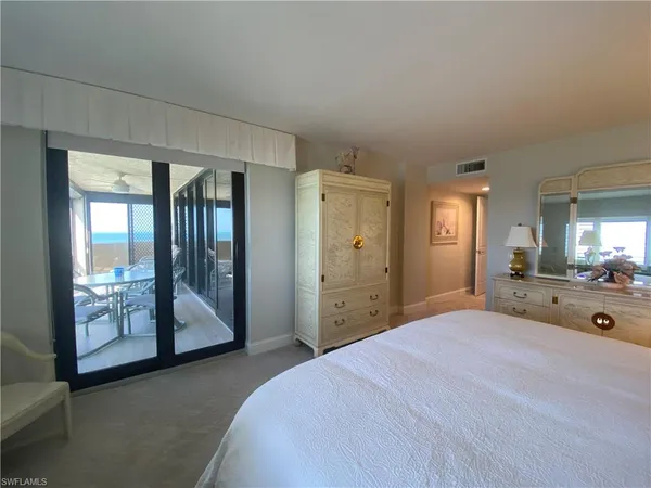 a bedroom with a bed and a mirror