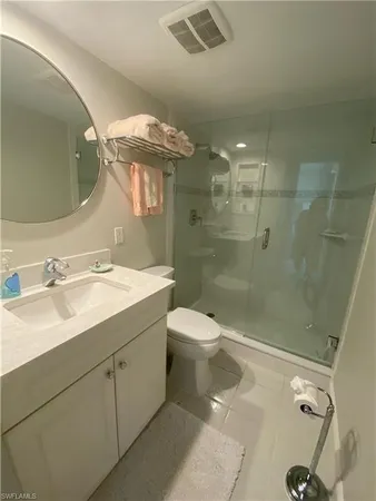 a bathroom with a double vanity sink toilet and shower