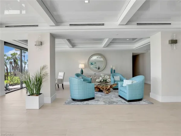 a living room with lots of furniture and a large window