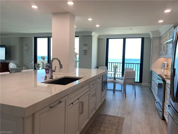 a kitchen with sink cabinets and wooden floor