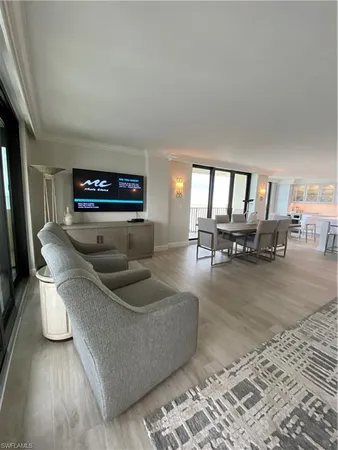 a living room with furniture and a piano
