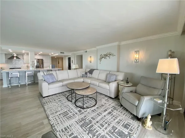 a living room with furniture and a lamp