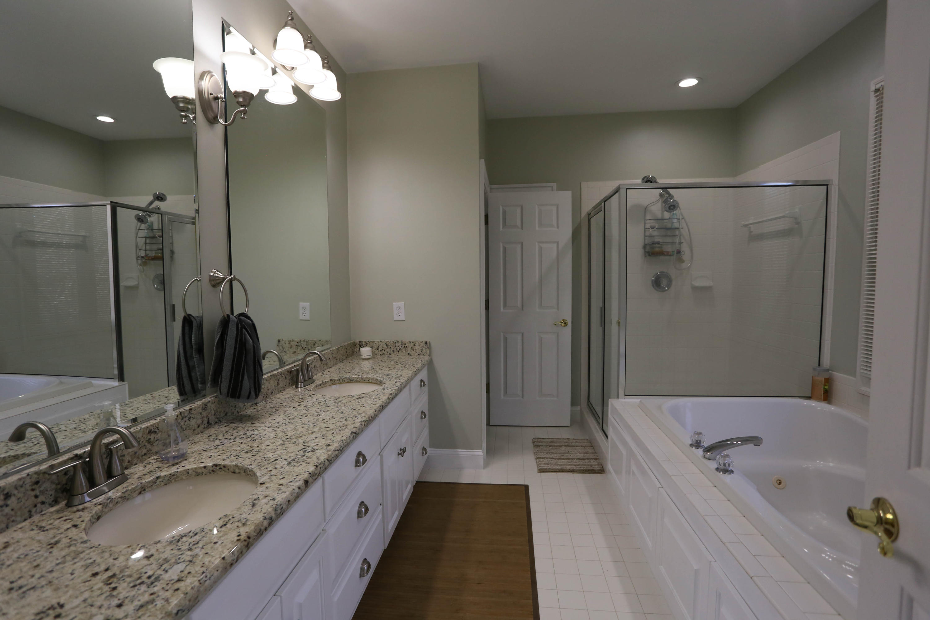6715 Fairway Ridge Road Roanoke, VA 24018 - Photo 16 of 35 a bathroom with a granite countertop double vanity sink a large mirror and shower