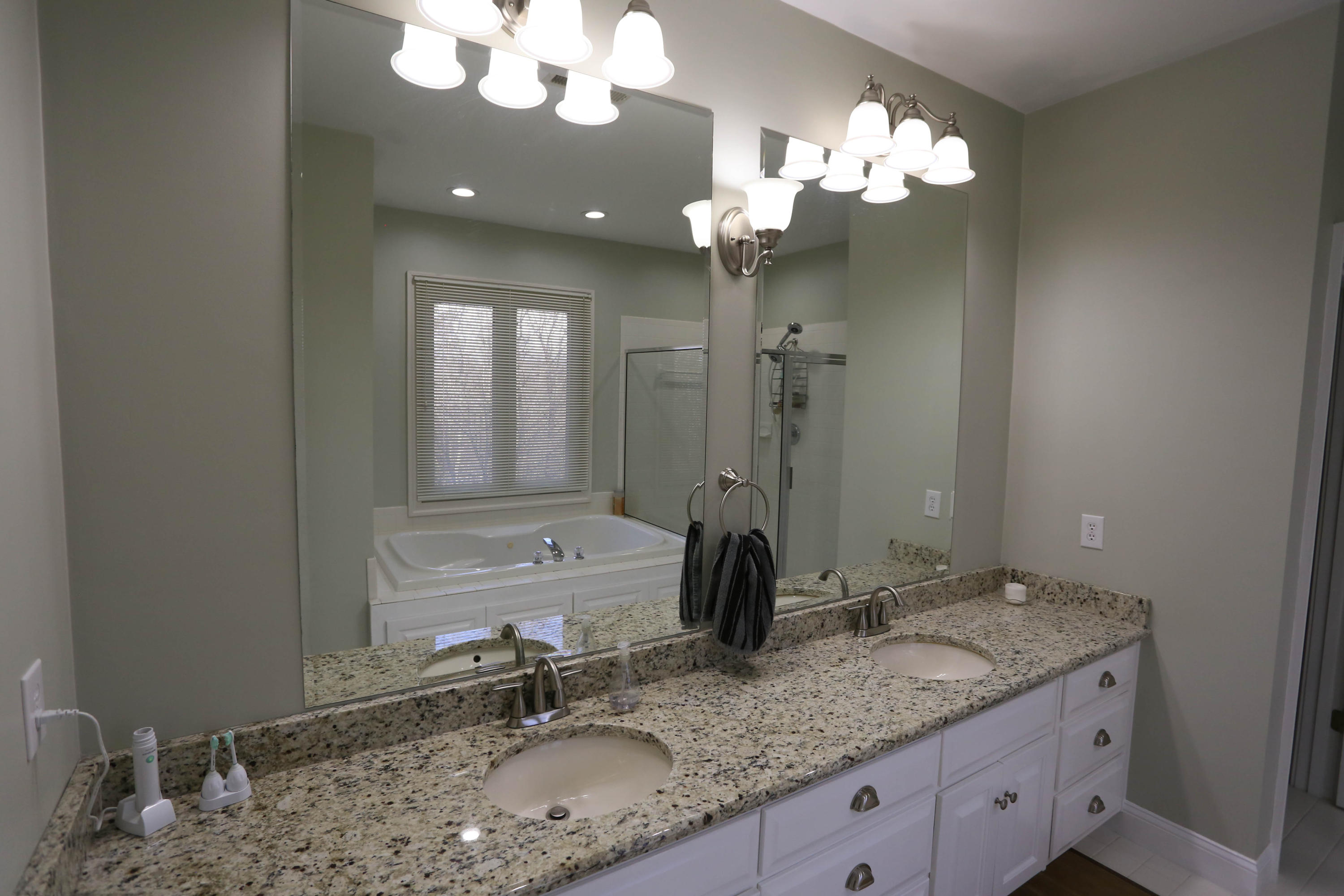 6715 Fairway Ridge Road Roanoke, VA 24018 - Photo 18 of 35 a bathroom with a granite countertop sink a large mirror and a shower