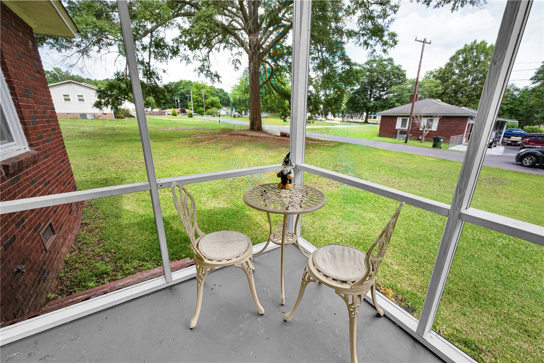 102 Graham Honea Path, SC 29654 - Photo 4 of 29 A tranquil screened porch invites relaxation, offering views of a broad green yard.