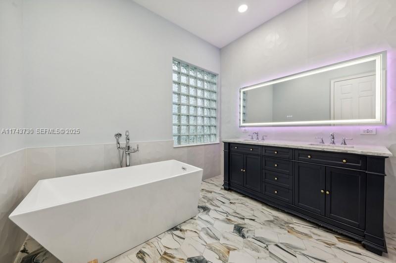 8911 Chestnut Ridge Way Boynton Beach, FL 33473 - Photo 11 of 20 a bath tub sitting next to a bathroom sink