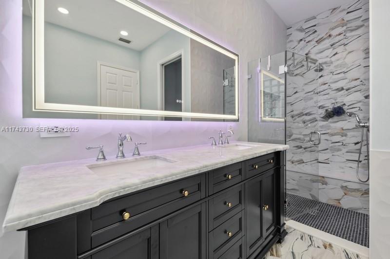 8911 Chestnut Ridge Way Boynton Beach, FL 33473 - Photo 12 of 20 a bathroom with a granite countertop sink a mirror and a