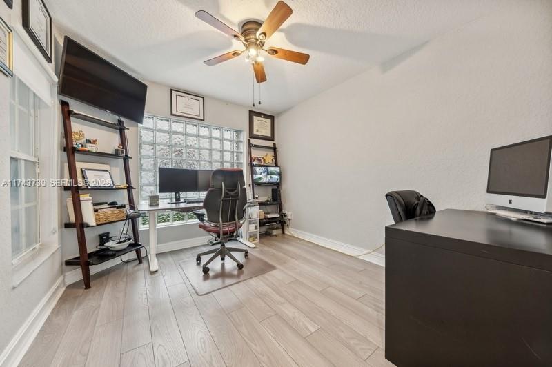 8911 Chestnut Ridge Way Boynton Beach, FL 33473 - Photo 15 of 20 a view of a workspace with furniture and a flat screen tv