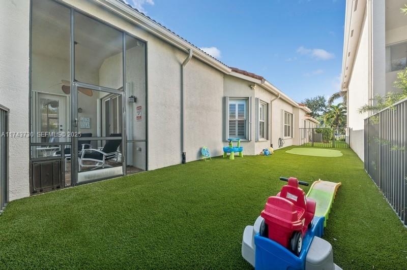 8911 Chestnut Ridge Way Boynton Beach, FL 33473 - Photo 18 of 20 a backyard of a house with table and chairs