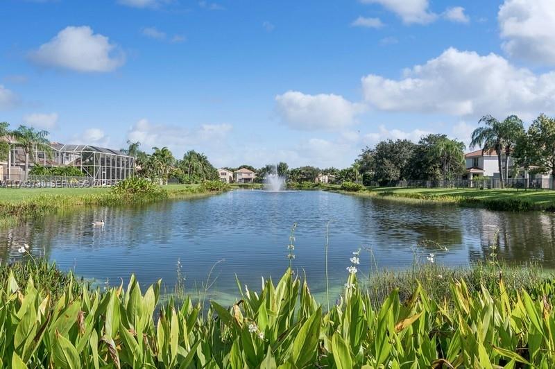 8911 Chestnut Ridge Way Boynton Beach, FL 33473 - Photo 20 of 20 a view of a lake with a house in the background