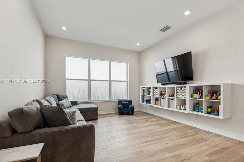 8911 Chestnut Ridge Way Boynton Beach, FL 33473 - Photo 4 of 20 a living room with furniture and a flat screen tv