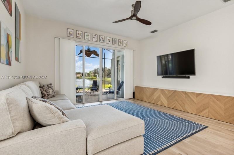8911 Chestnut Ridge Way Boynton Beach, FL 33473 - Photo 5 of 20 a living room with couches and a flat screen tv