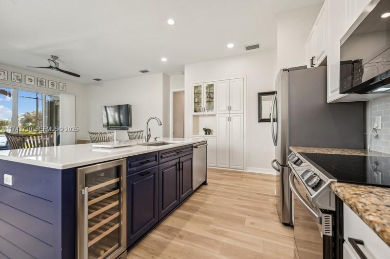 8911 Chestnut Ridge Way Boynton Beach, FL 33473 - Photo 8 of 20 a kitchen with stainless steel appliances granite countertop a sink and cabinets