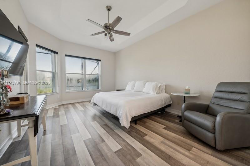 8911 Chestnut Ridge Way Boynton Beach, FL 33473 - Photo 10 of 20 a bed room with a bed a couch and a window