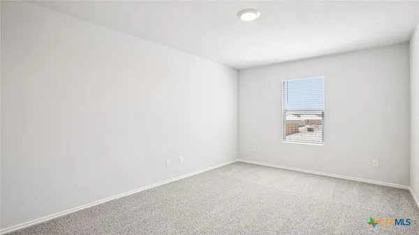 a view of an empty room and a window