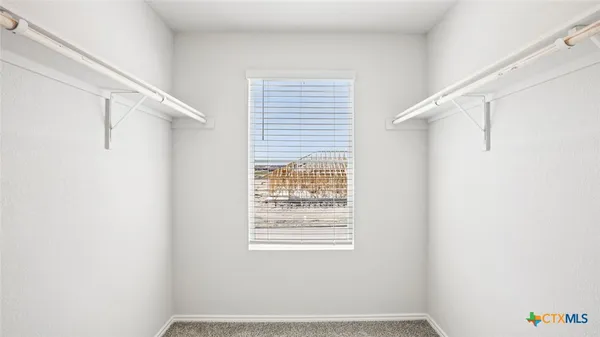 a view of a room with a window and a fan