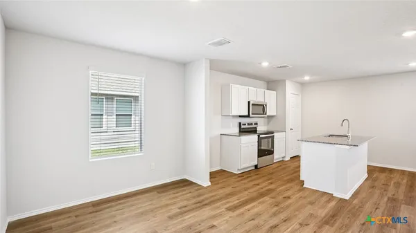 a kitchen with a refrigerator and a sink