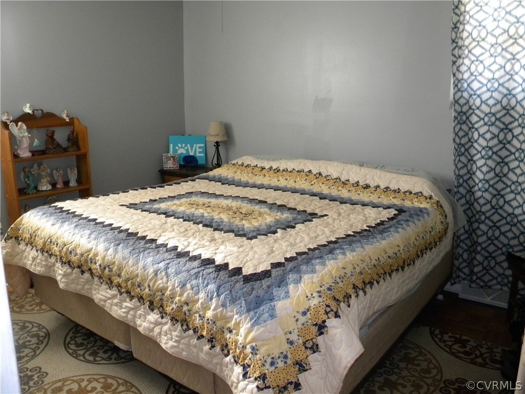 4602 Mizar Road Henrico, VA 23231 - Photo 9 of 13 a bed sitting in a bedroom next to a window