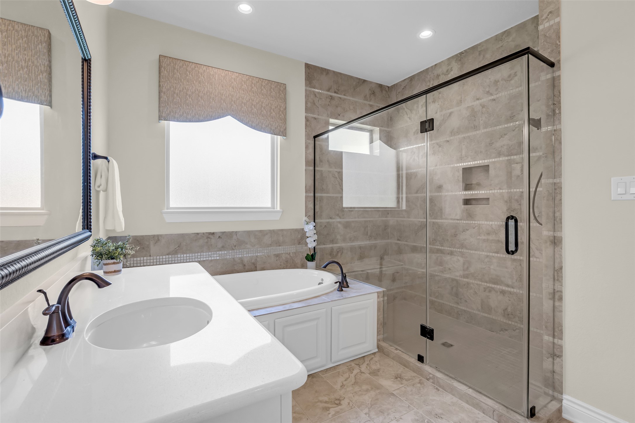14003 South Evergreen Ridge Court Conroe, TX 77384 - Photo 23 of 43 Primary bath features a soaking tub, oversized frameless glass shower, and elegant tile finishes.