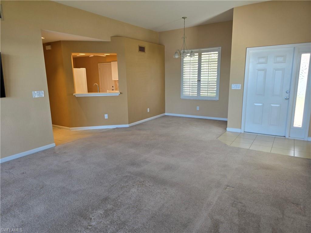 25069 Peacock Lane, Unit 101 Naples, FL 34114 - Photo 11 of 49 an empty room with windows and closet