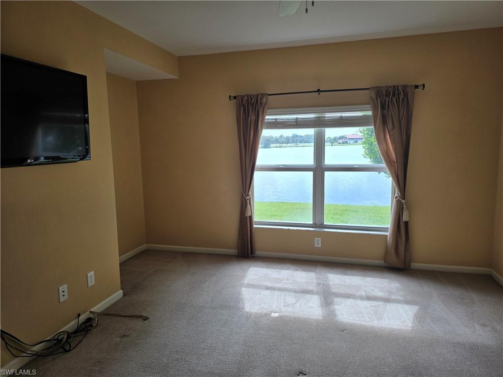 25069 Peacock Lane, Unit 101 Naples, FL 34114 - Photo 17 of 49 wooden floor and window in an empty room