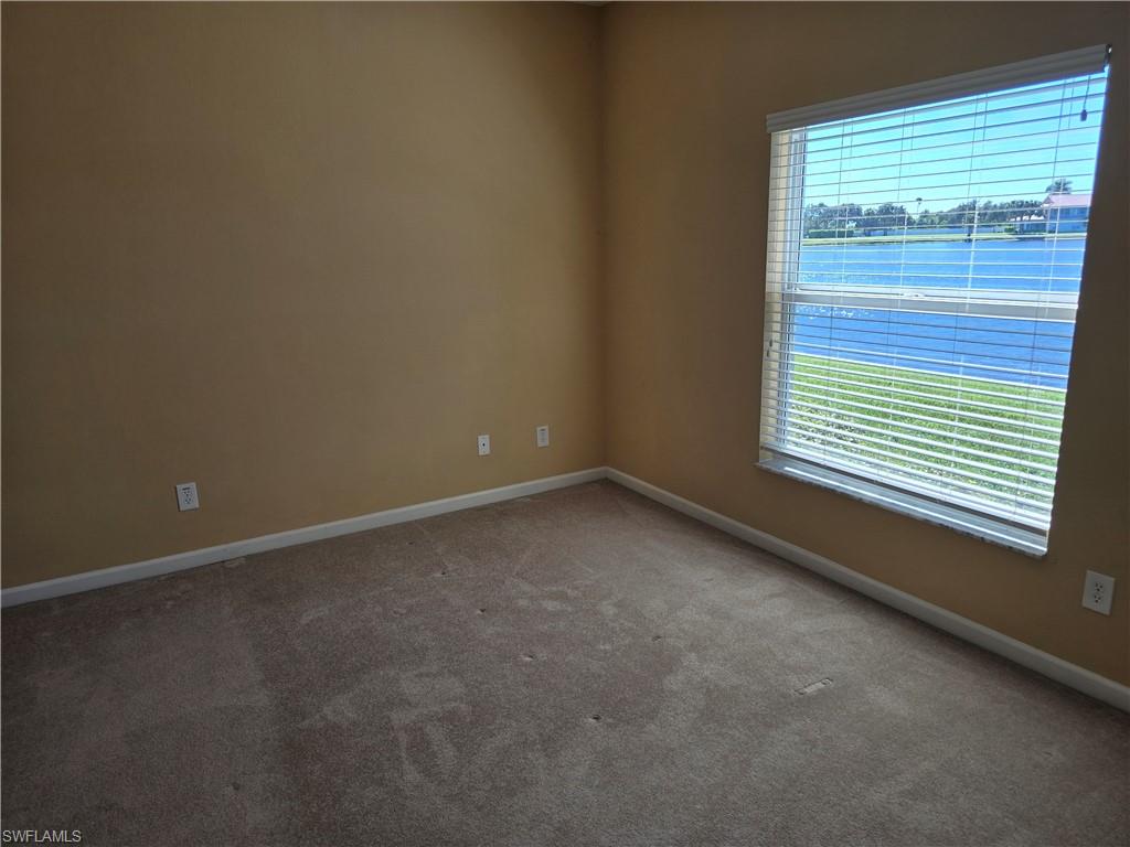 25069 Peacock Lane, Unit 101 Naples, FL 34114 - Photo 18 of 49 a view of an empty room with a window