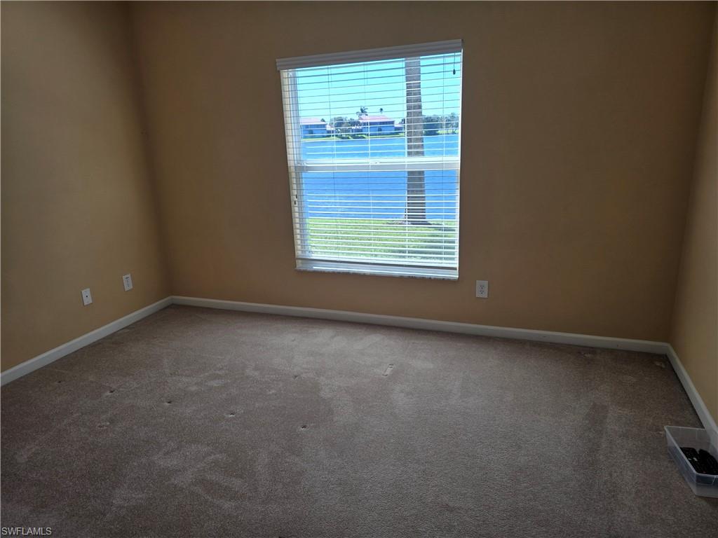 25069 Peacock Lane, Unit 101 Naples, FL 34114 - Photo 19 of 49 an empty room with a window