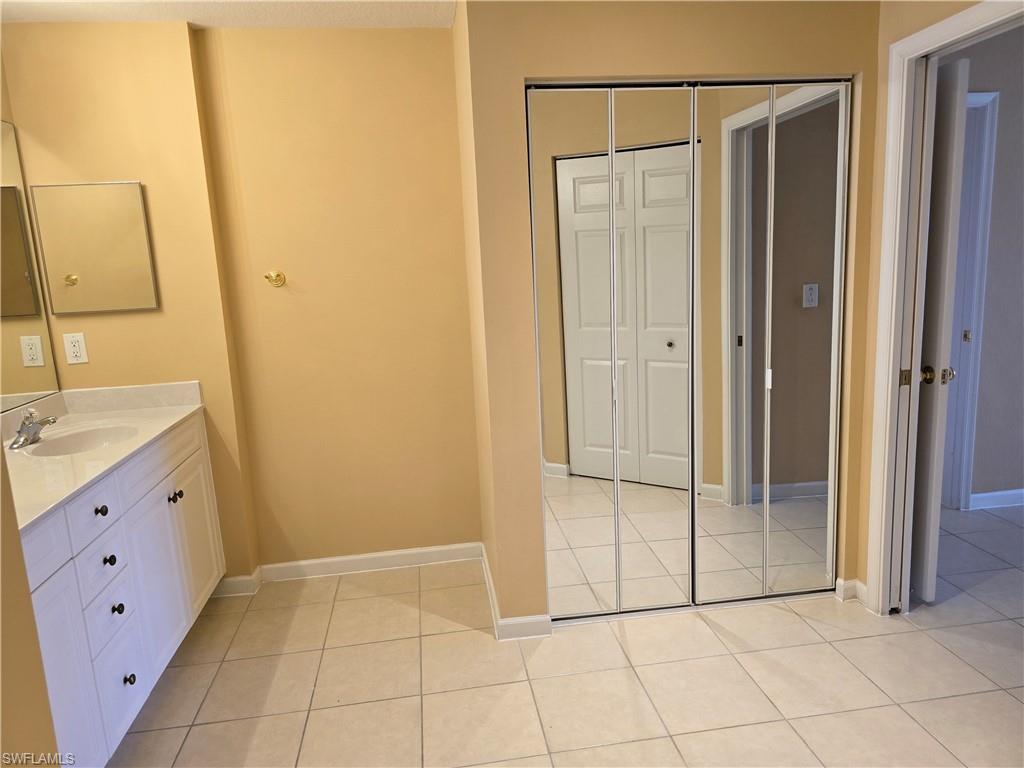 25069 Peacock Lane, Unit 101 Naples, FL 34114 - Photo 22 of 49 a view of a bathroom with sink shower and mirror