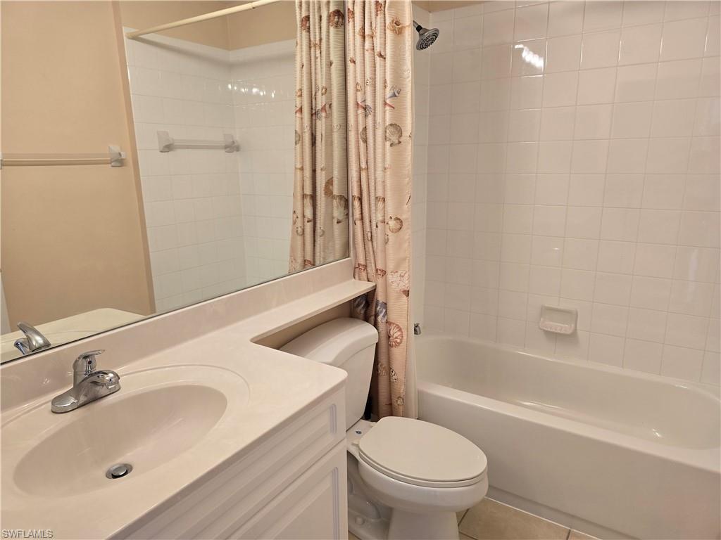 25069 Peacock Lane, Unit 101 Naples, FL 34114 - Photo 37 of 49 a bathroom with a sink a toilet and shower