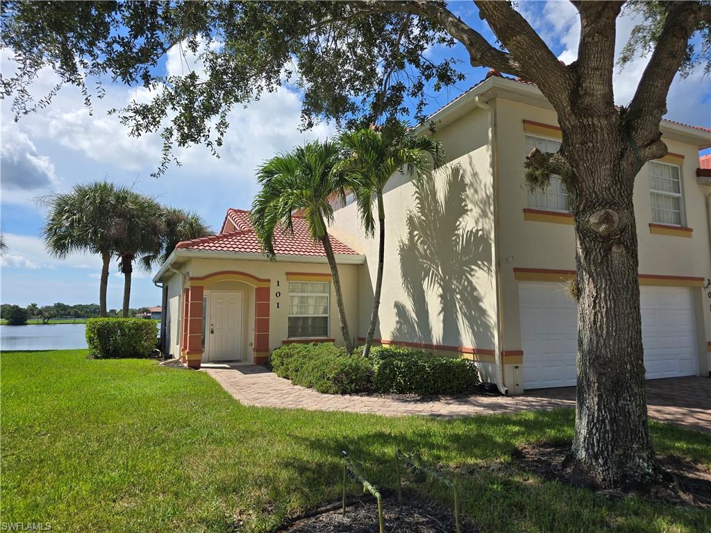 25069 Peacock Lane, Unit 101 Naples, FL 34114 - Photo 7 of 49 a front view of a house with a garden and tree