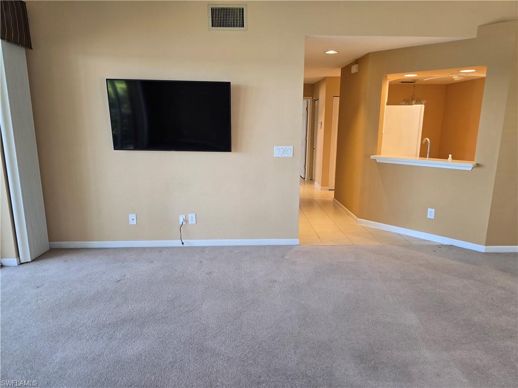 25069 Peacock Lane, Unit 101 Naples, FL 34114 - Photo 10 of 49 a view of an empty room with windows