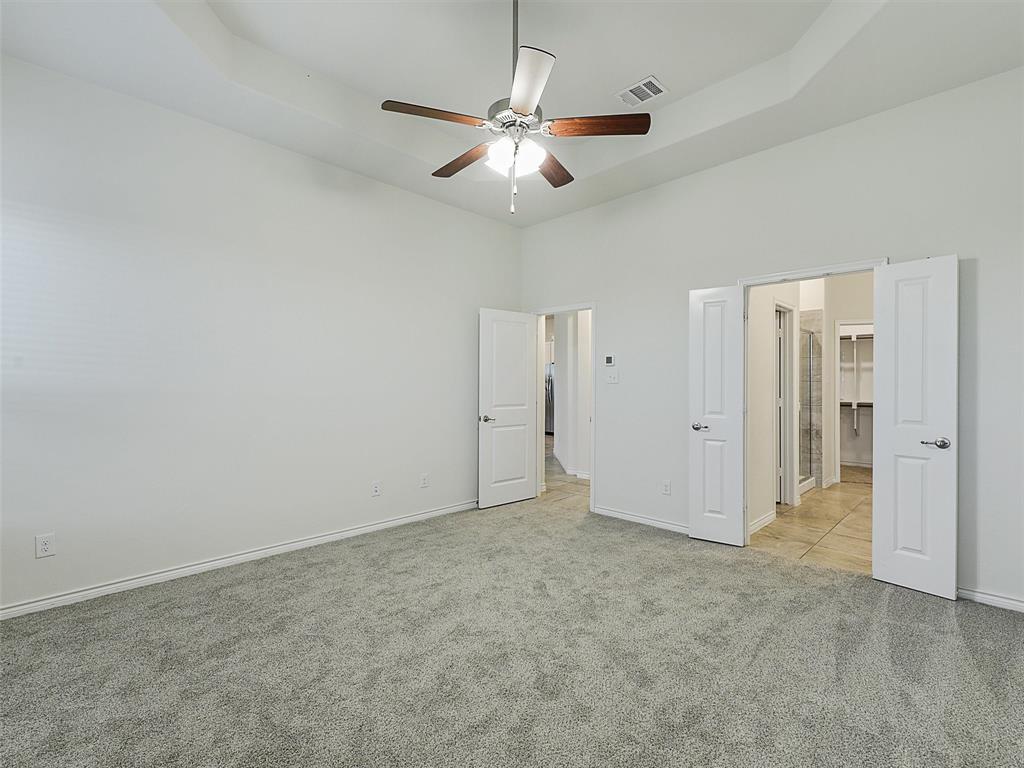 421 Maverick Street Anna, TX 75409 - Photo 13 of 25 Unfurnished bedroom with light carpet, ceiling fan, and a tray ceiling