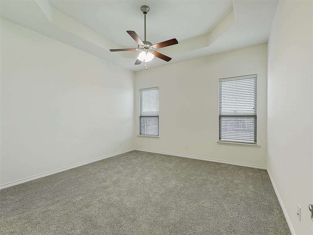 421 Maverick Street Anna, TX 75409 - Photo 16 of 25 Empty room with carpet flooring, a raised ceiling, and a ceiling fan