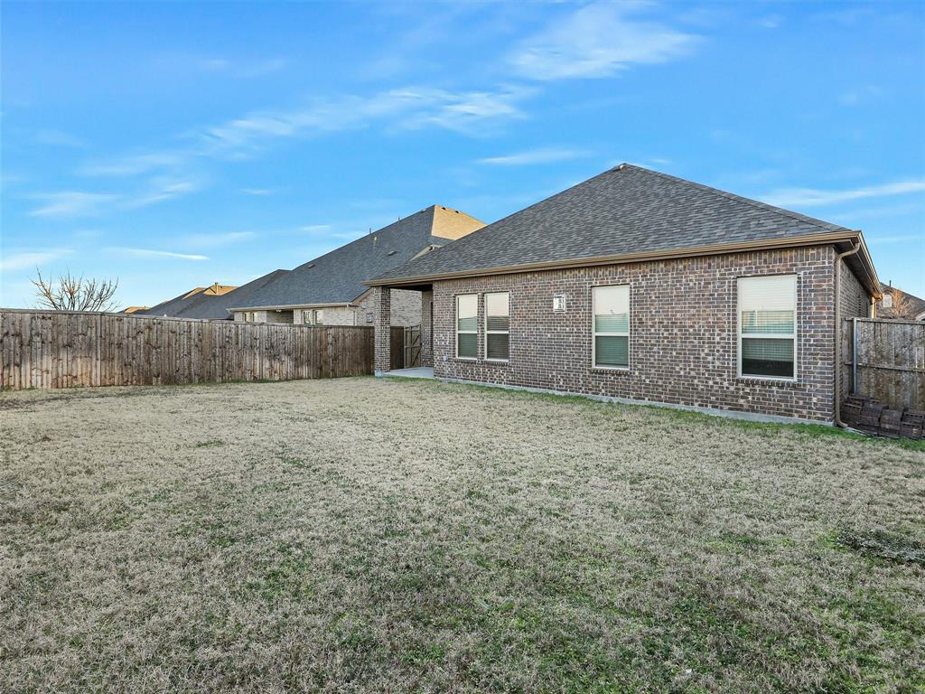 421 Maverick Street Anna, TX 75409 - Photo 23 of 25 Rear view of house featuring a patio, a shingled roof, brick siding, and a fenced backyard