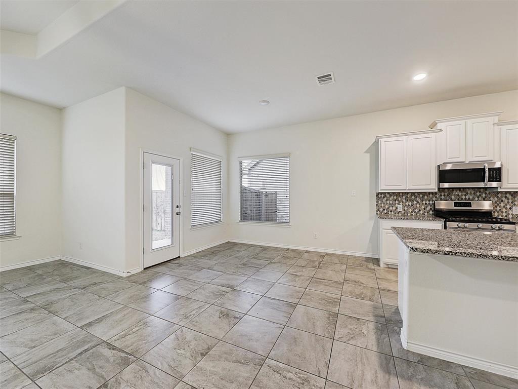 421 Maverick Street Anna, TX 75409 - Photo 9 of 25 Kitchen featuring light stone countertops, white cabinets, stainless steel appliances, backsplash, and recessed lighting
