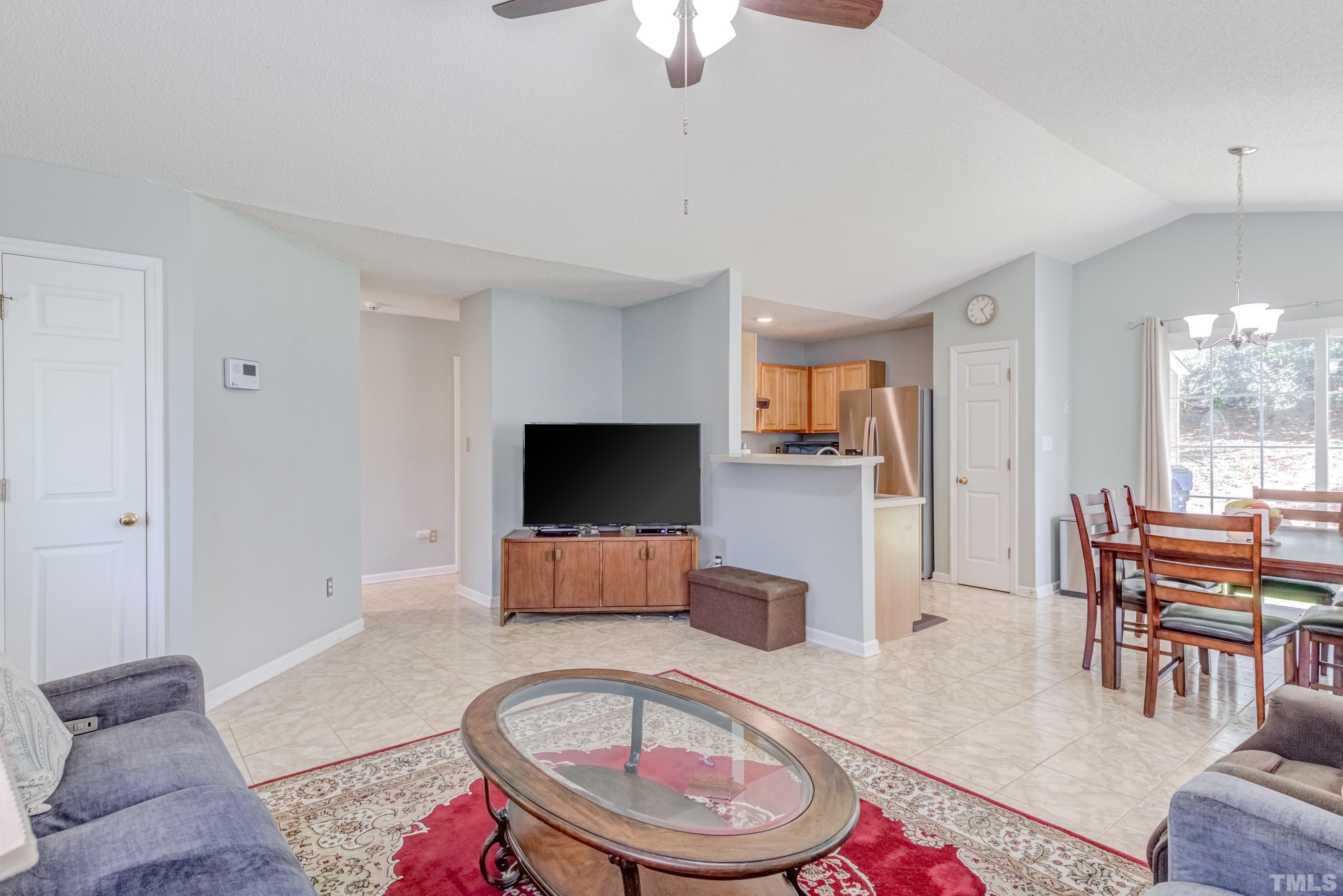 4917 Silverdene Street Raleigh, NC 27616 - Photo 13 of 37 a living room with furniture and a flat screen tv