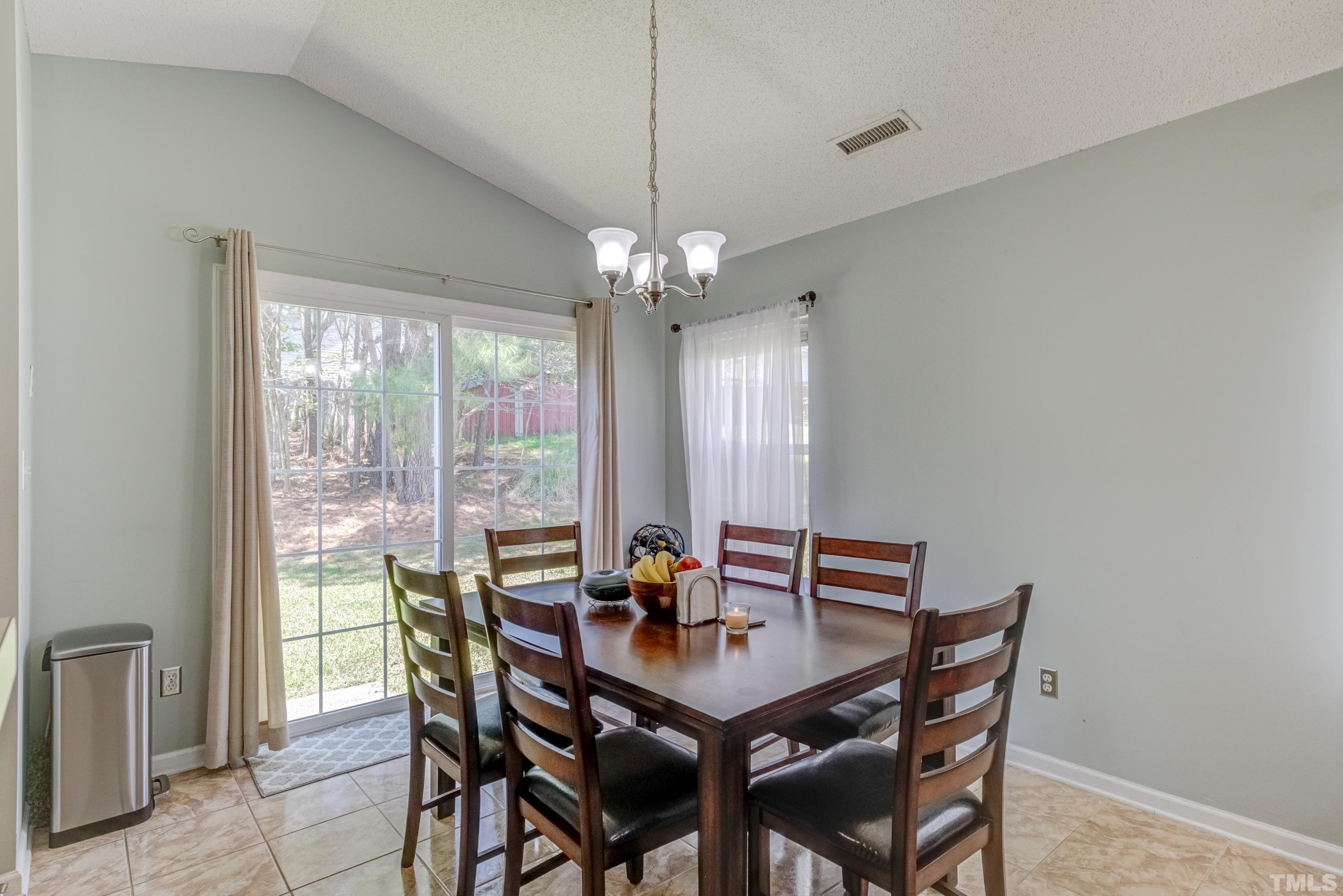 4917 Silverdene Street Raleigh, NC 27616 - Photo 14 of 37 a view of a dining room with furniture window and outside view