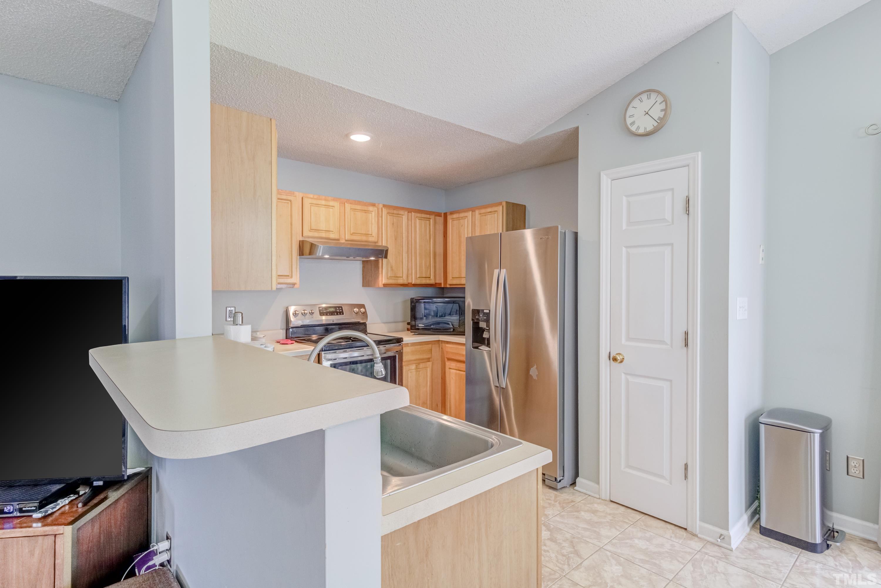 4917 Silverdene Street Raleigh, NC 27616 - Photo 18 of 37 a kitchen with refrigerator cabinets and furniture