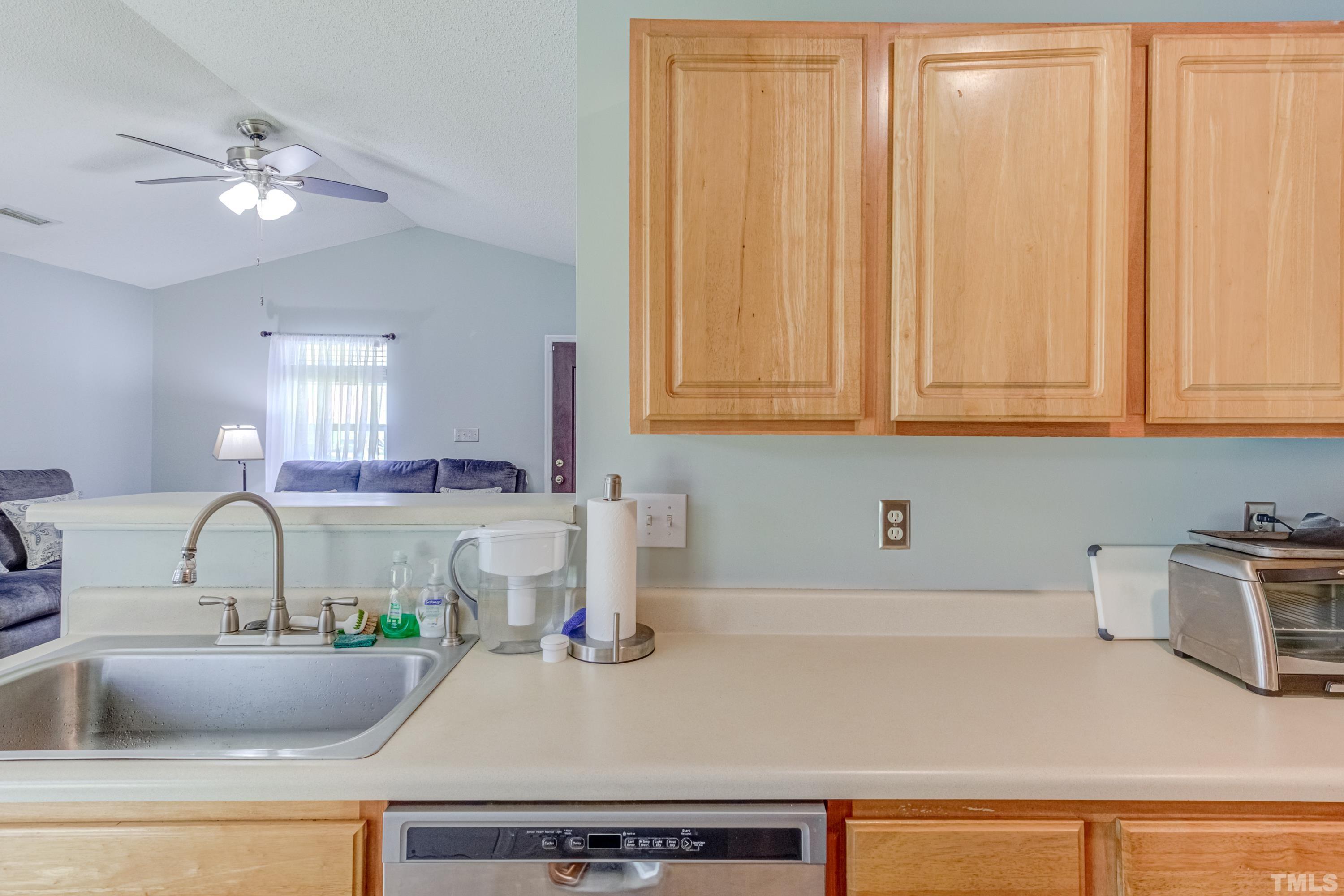 4917 Silverdene Street Raleigh, NC 27616 - Photo 19 of 37 a kitchen with a sink and cabinets