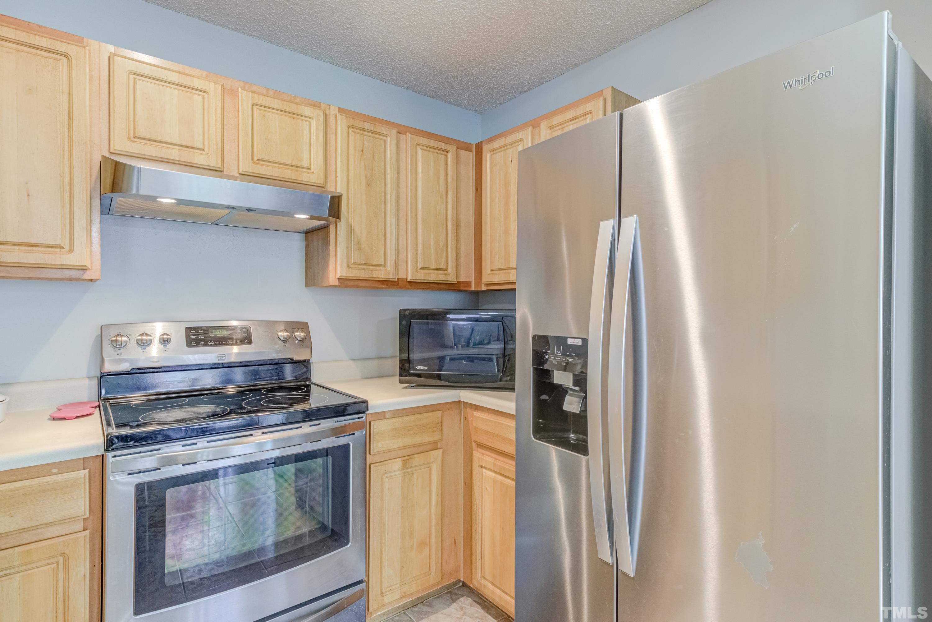4917 Silverdene Street Raleigh, NC 27616 - Photo 20 of 37 a kitchen with stainless steel appliances granite countertop a refrigerator sink and stove