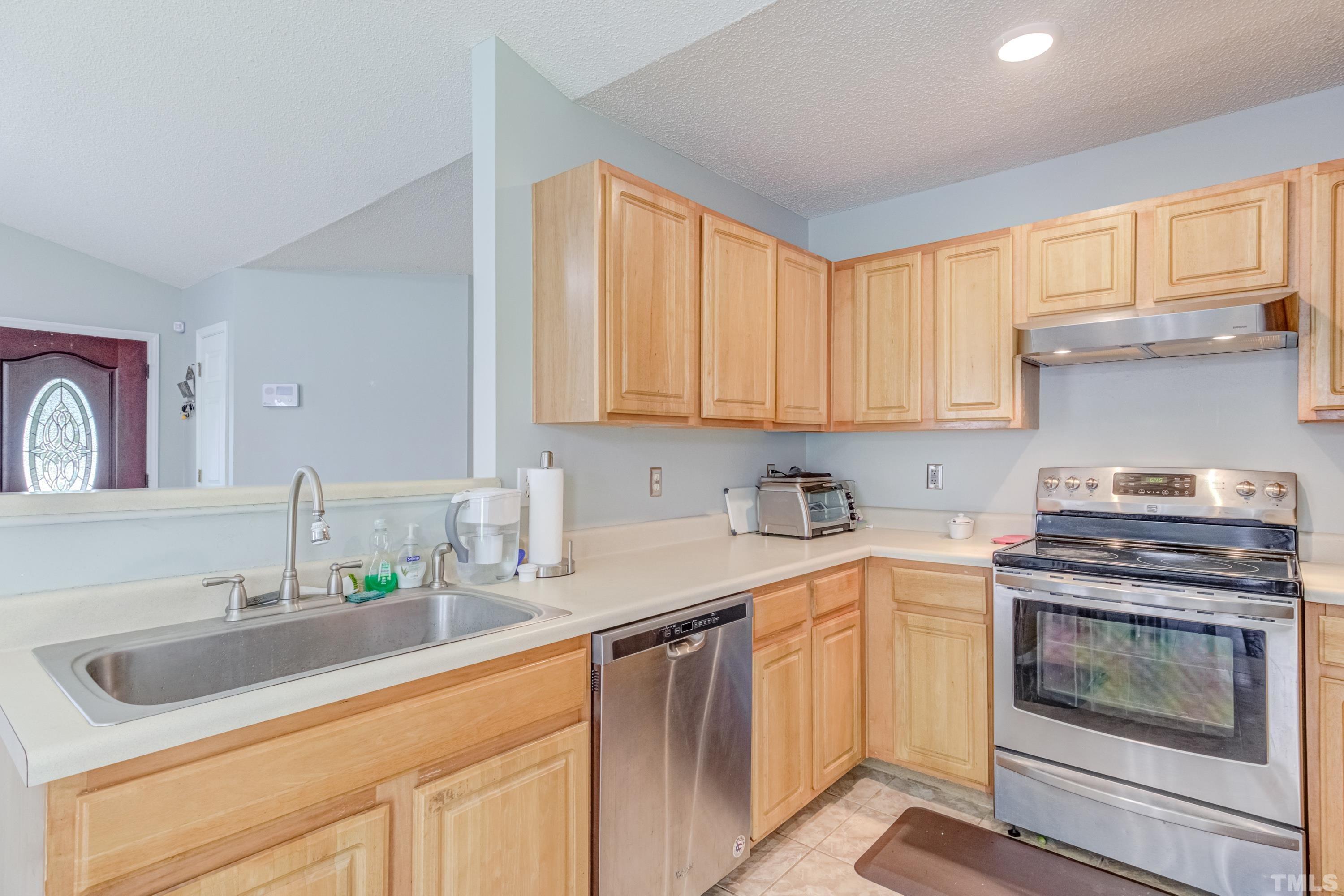 4917 Silverdene Street Raleigh, NC 27616 - Photo 21 of 37 a kitchen with a sink stove and cabinets
