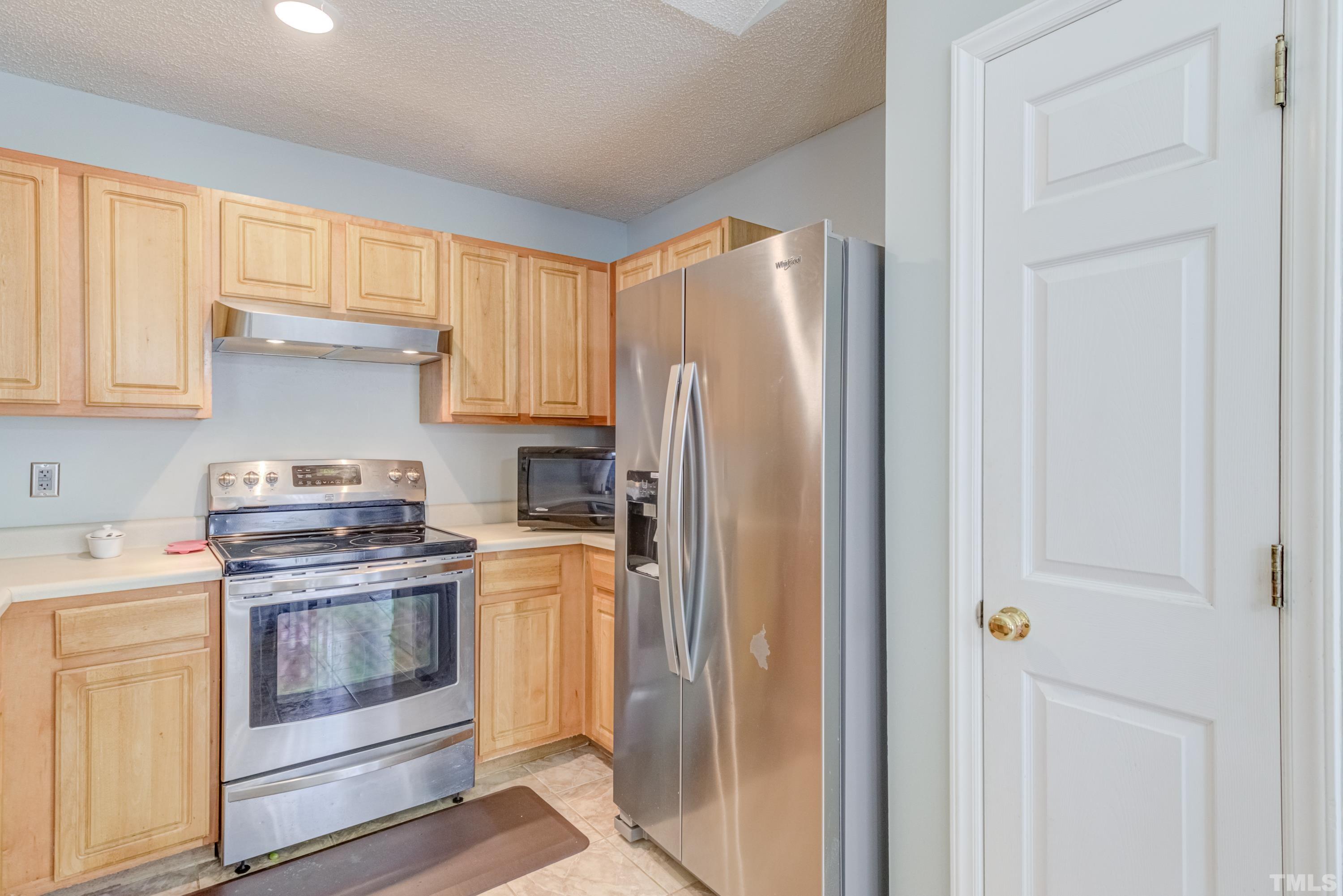 4917 Silverdene Street Raleigh, NC 27616 - Photo 22 of 37 a kitchen with a stove and a refrigerator