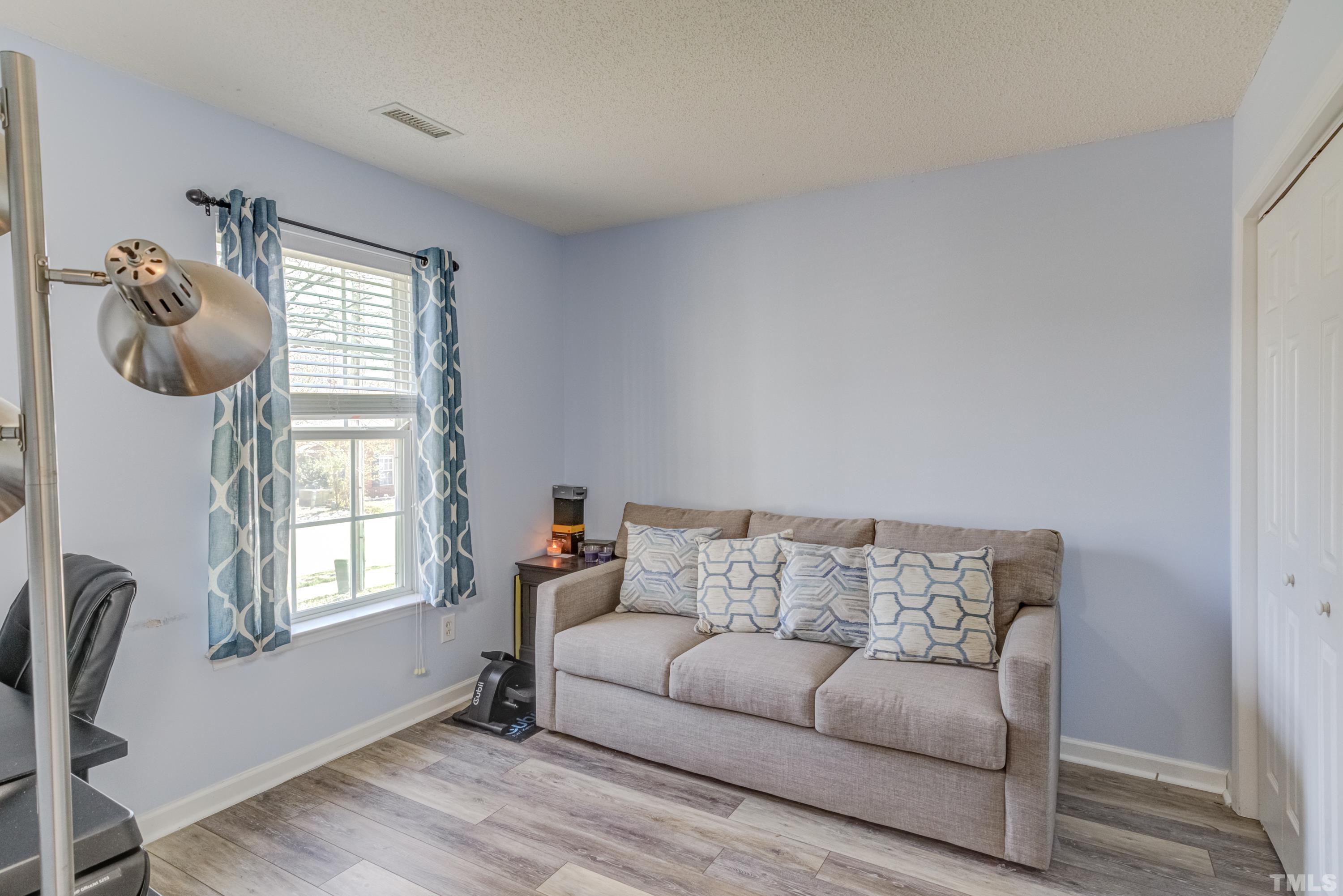 4917 Silverdene Street Raleigh, NC 27616 - Photo 23 of 37 a living room with furniture and a window