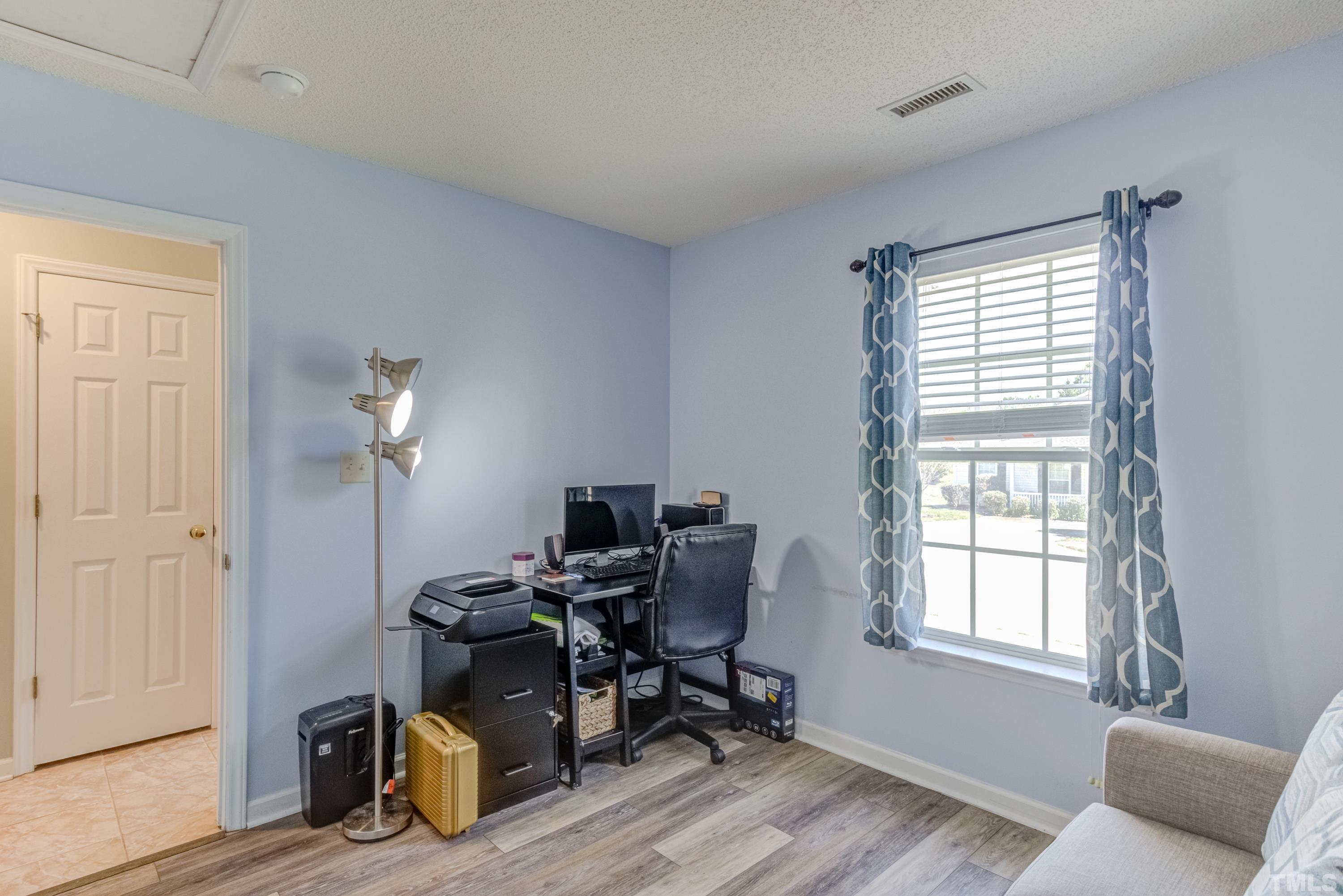 4917 Silverdene Street Raleigh, NC 27616 - Photo 24 of 37 a view of a workspace with furniture and a window