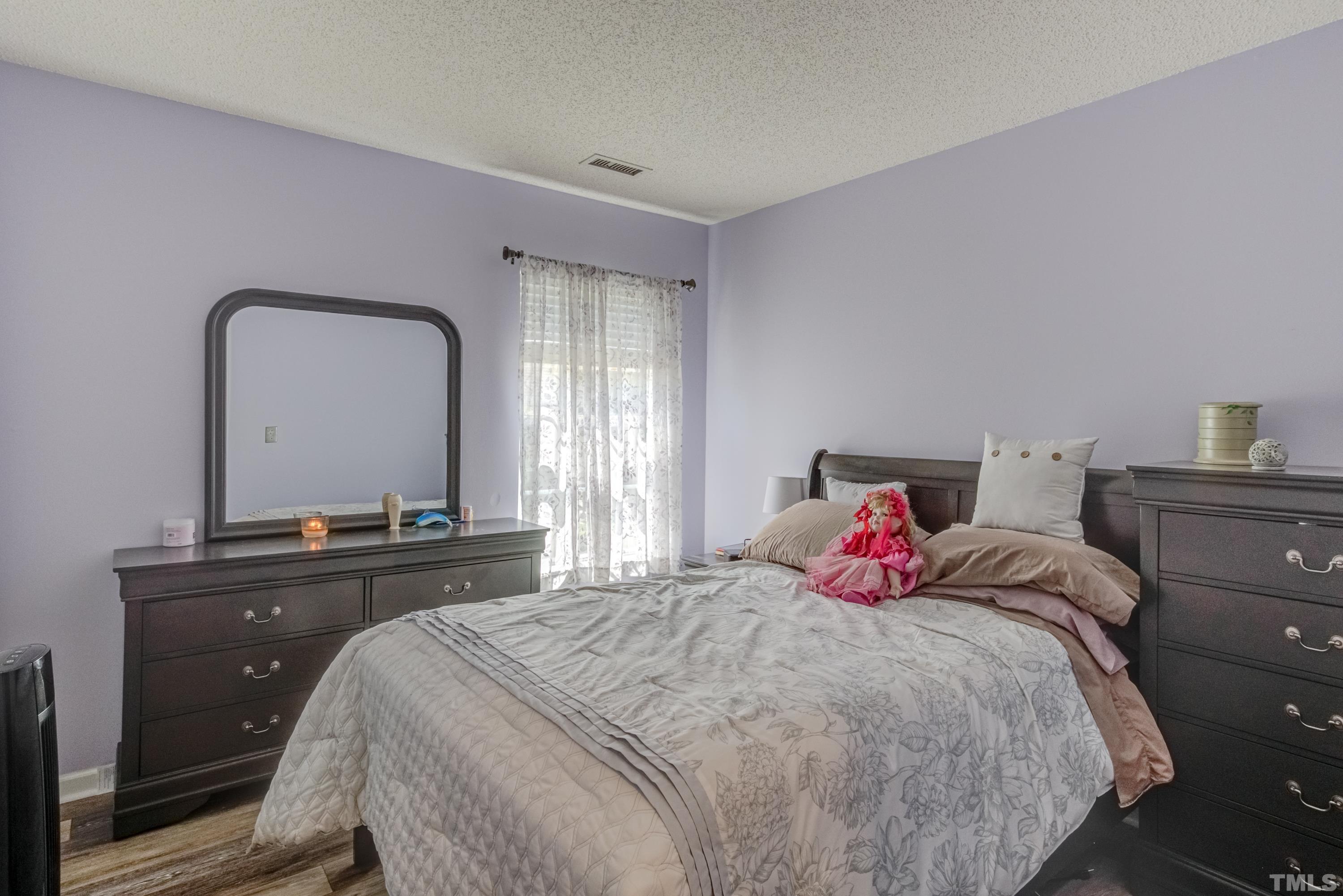 4917 Silverdene Street Raleigh, NC 27616 - Photo 26 of 37 a bedroom with a bed and a dresser
