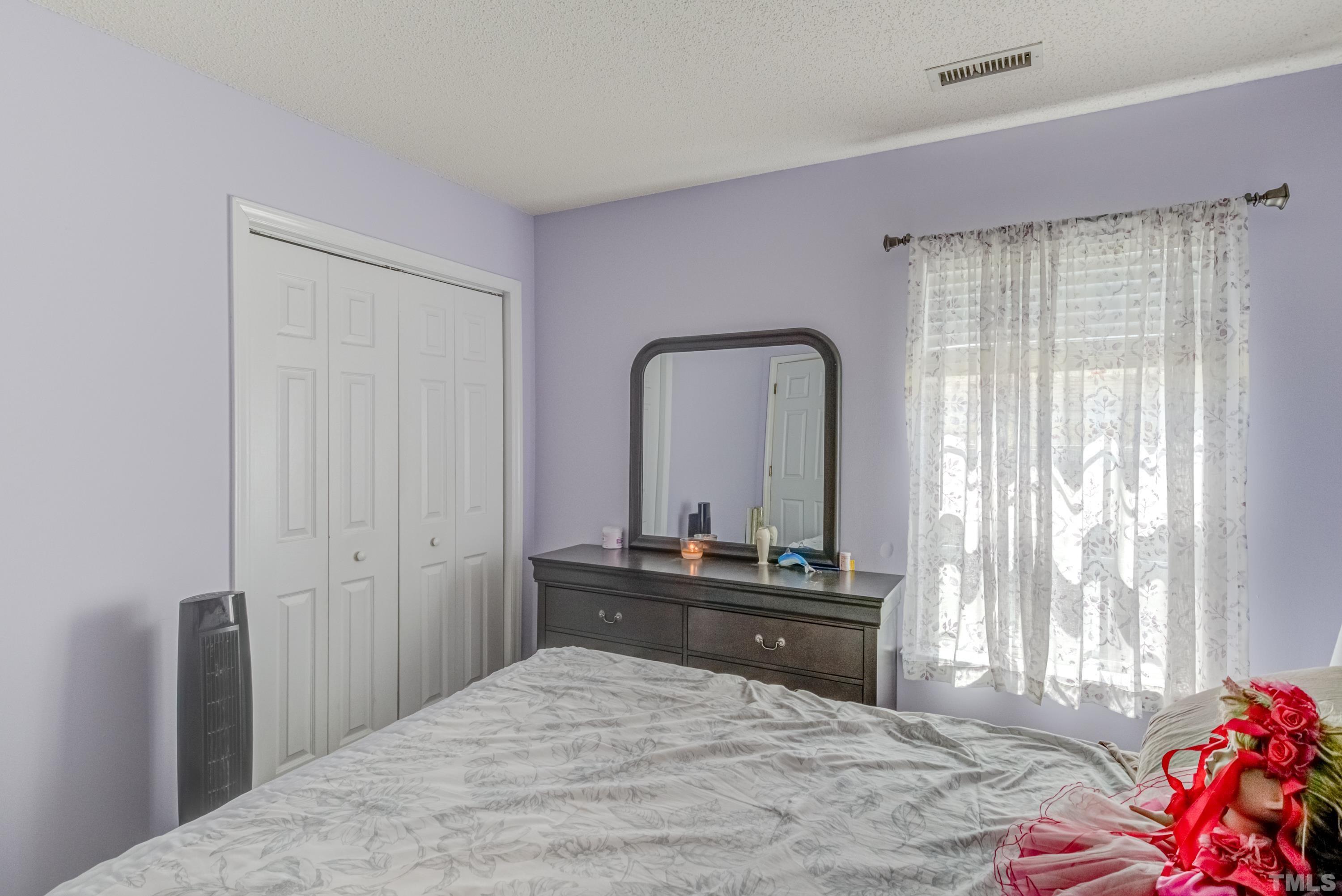 4917 Silverdene Street Raleigh, NC 27616 - Photo 27 of 37 a bedroom with a bed and a dresser