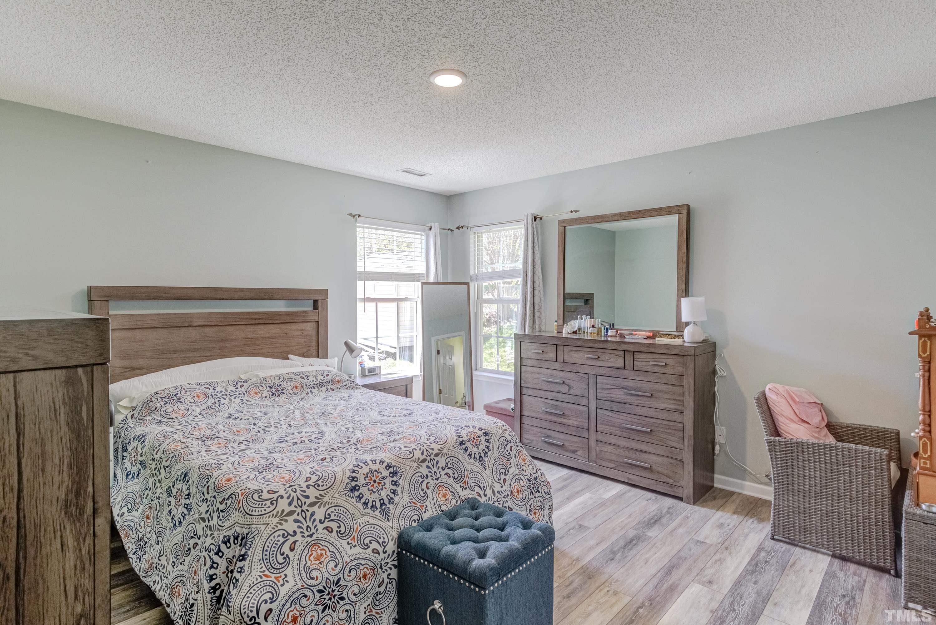 4917 Silverdene Street Raleigh, NC 27616 - Photo 28 of 37 a bedroom with a bed and wooden floor