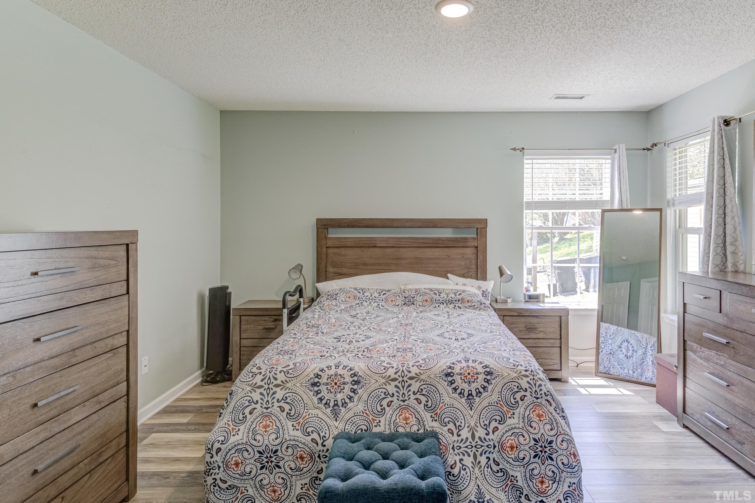 4917 Silverdene Street Raleigh, NC 27616 - Photo 29 of 37 a bedroom with a large bed and a window