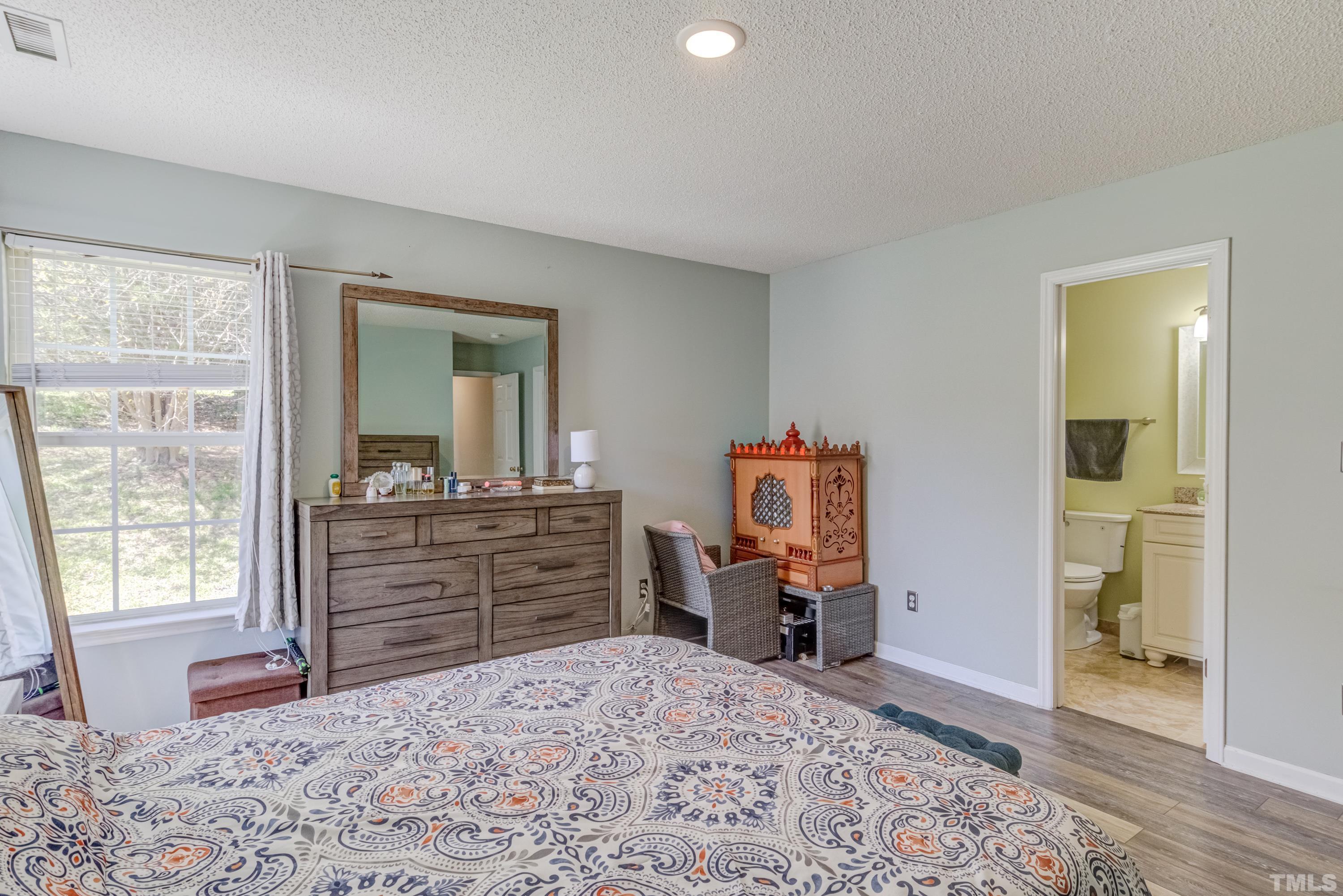 4917 Silverdene Street Raleigh, NC 27616 - Photo 30 of 37 a bed room with a bed and a dresser